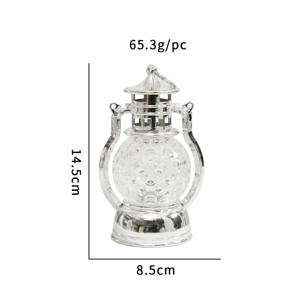 Creative retro-style small oil lamp LED night light in gold or silver finish on a table.