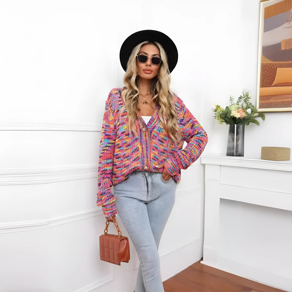 Rainbow striped loose fit knitted cardigan coat on a hanger, rose red with multicolour stripes.
