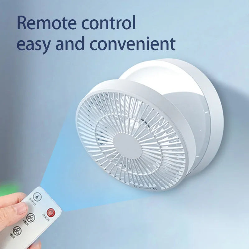 White portable USB rechargeable fan with remote control on a desk, showing its folding head and night light.