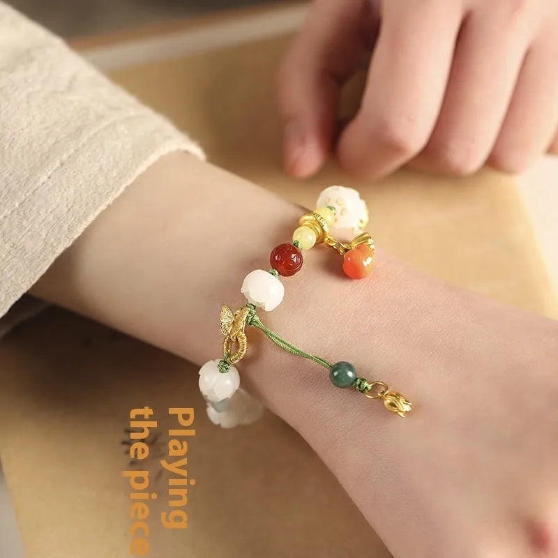 Hand-woven white jade Bodhi bracelet with lucky persimmon charm and three bead sizes on open rope