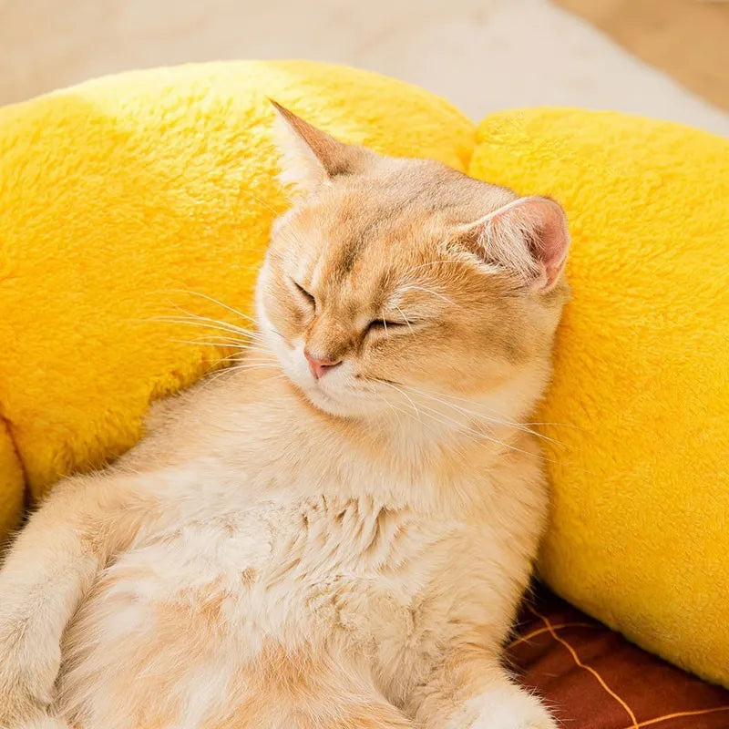 Soft yellow sunflower patterned pet nest cushion for cats and small dogs on a wooden floor.