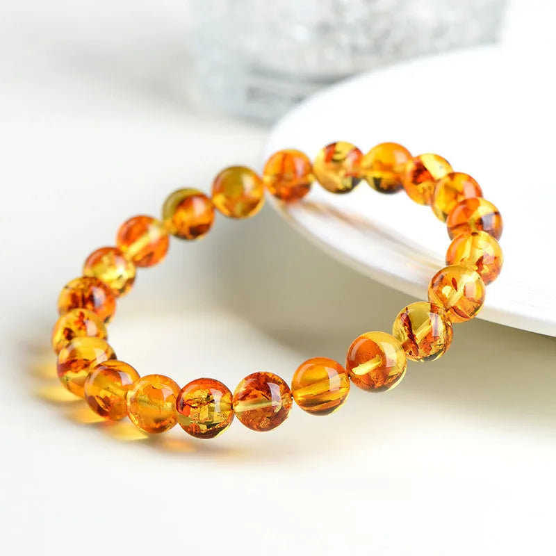 Natural yellow piebald amber bracelet with geometric beads and water purification properties