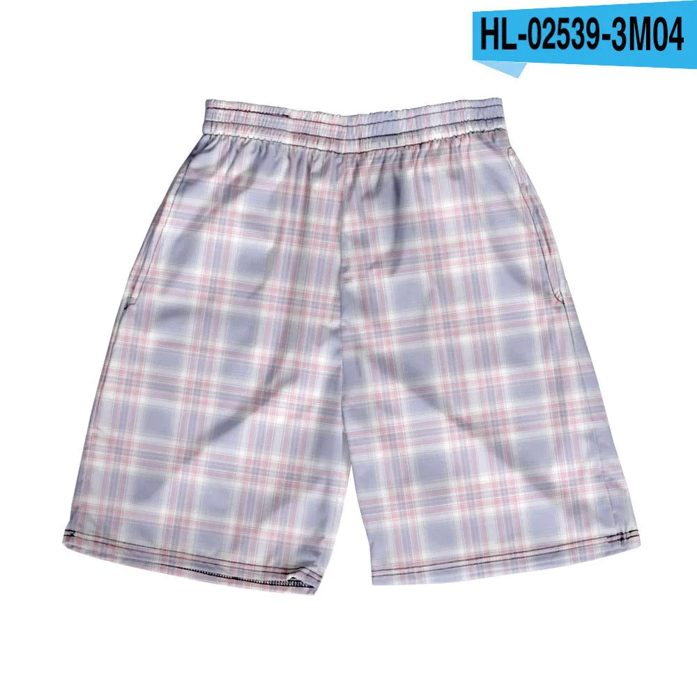 Man wearing grey plaid casual shorts with an elastic waistband, on a beach.