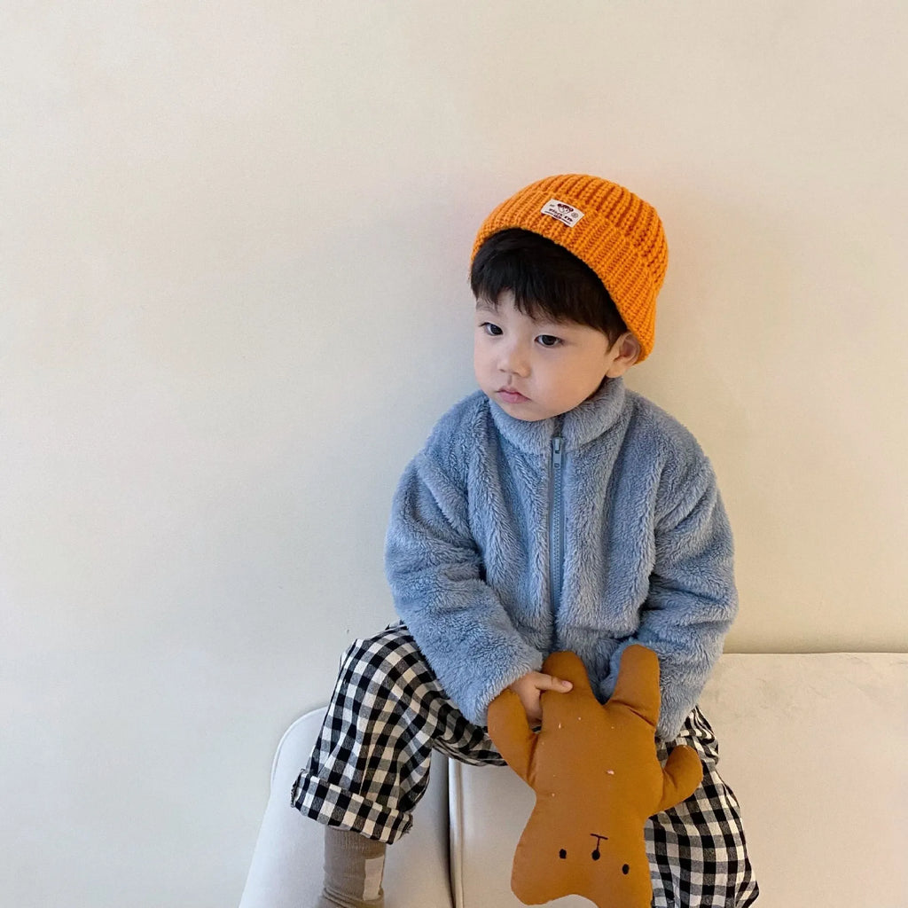 Child wearing blue sherpa fleece winter coat with full-zip front and standing collar