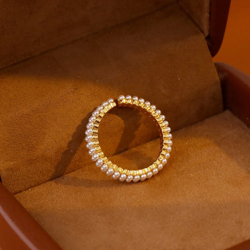 Gold-coloured geometric open-mouth ring with pearl detailing on copper electroplated band