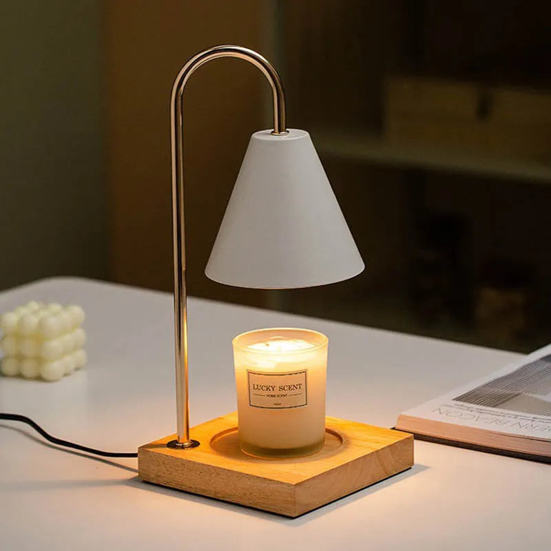 White and log coloured electric candle warmer lamp with dimmer switch on desk