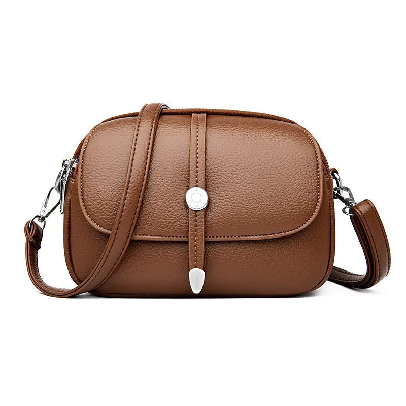 Women's soft PU oval crossbody shoulder bag with sewing thread detailing in dark brown