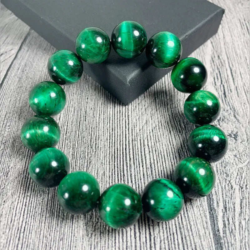 Green tiger eye stone bracelet with geometric beads in hand-polished finish showing natural colour banding