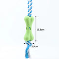 Green porous bone-shaped dog toy with rope knot texture for treat stuffing and teeth cleaning
