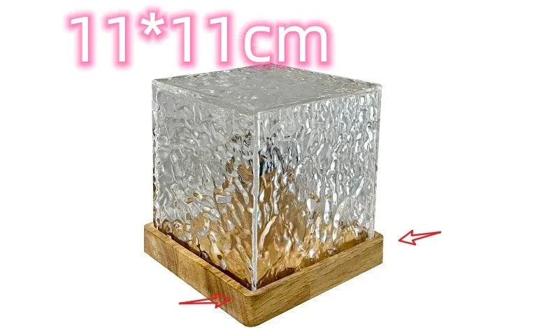 USB rechargeable LED water ripple night light with remote control on a table.