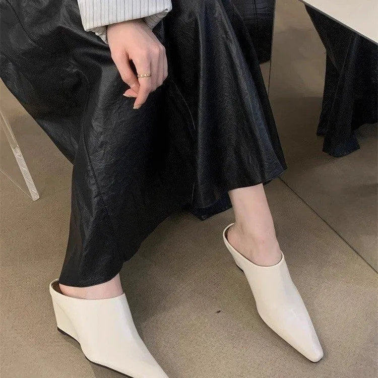Women's black Wind Wedge closed toe half slippers with PU upper on a plain background.