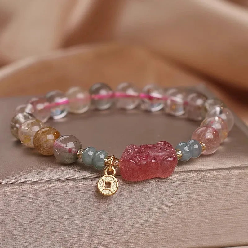 Colour hair crystal cat's paw charm bracelet with zircon butterfly on wrist.