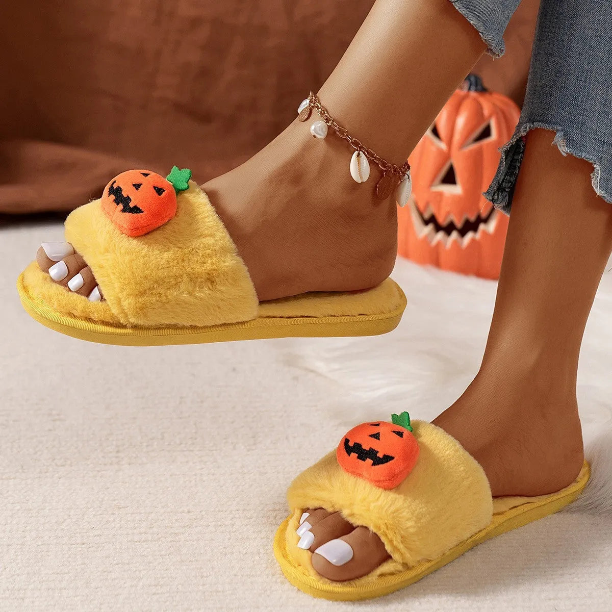 Halloween pumpkin plush slippers with open toe design showing synthetic fur uppers and PVC soles