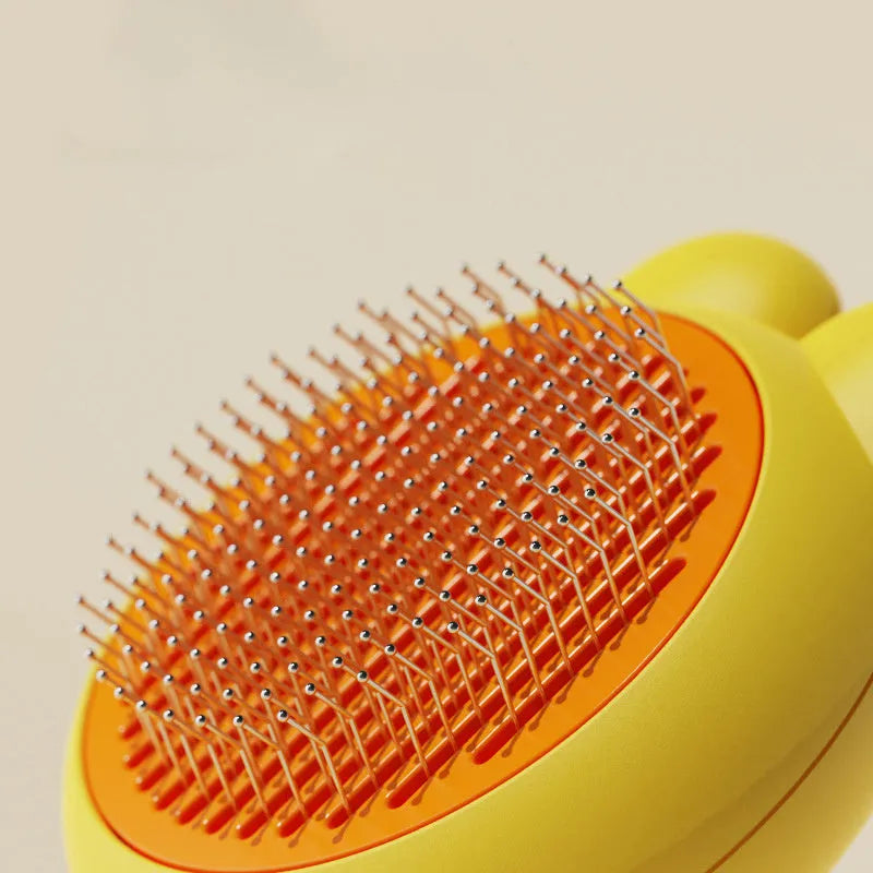 Cat grooming brush with green handle, self-cleaning button, and stainless steel comb for pet hair removal