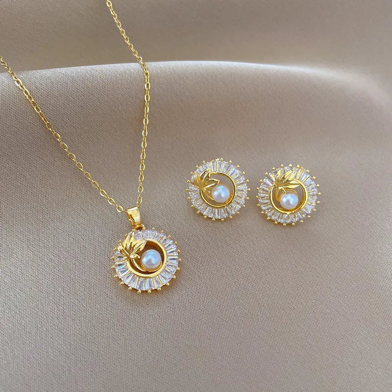 Women's geometric jewellery set with square full diamond motif, leaf design, titanium steel chain, and gold-plated copper pendant and earrings.