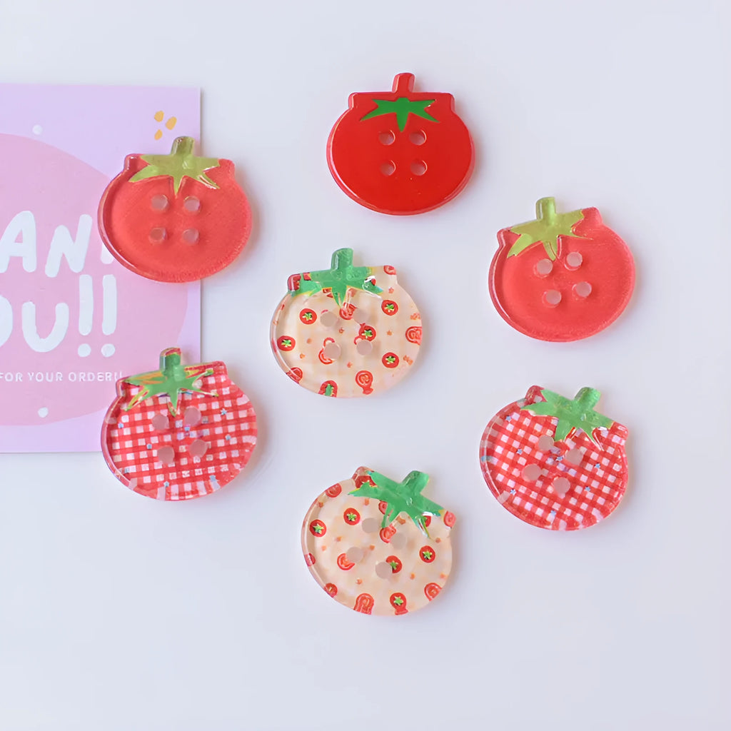 Medium size red tomato pattern button ornaments made from plastic resin, shown in different colour variations.