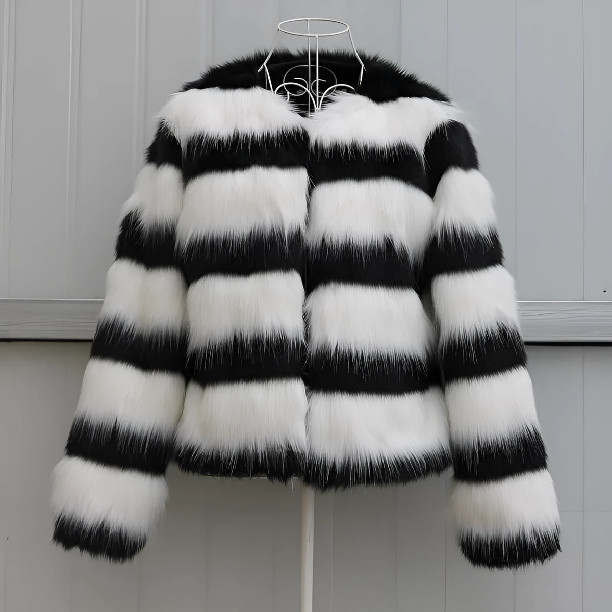 Black and white striped faux fur jacket with long sleeves on female model