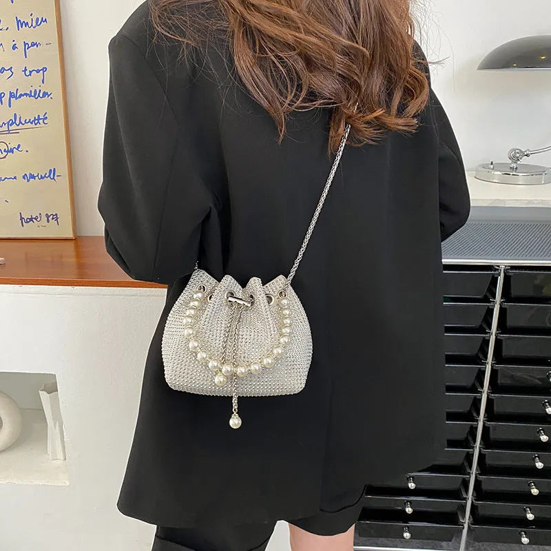 Light diamond shoulder crossbody bag with chain strap and bucket shape in soft PU.