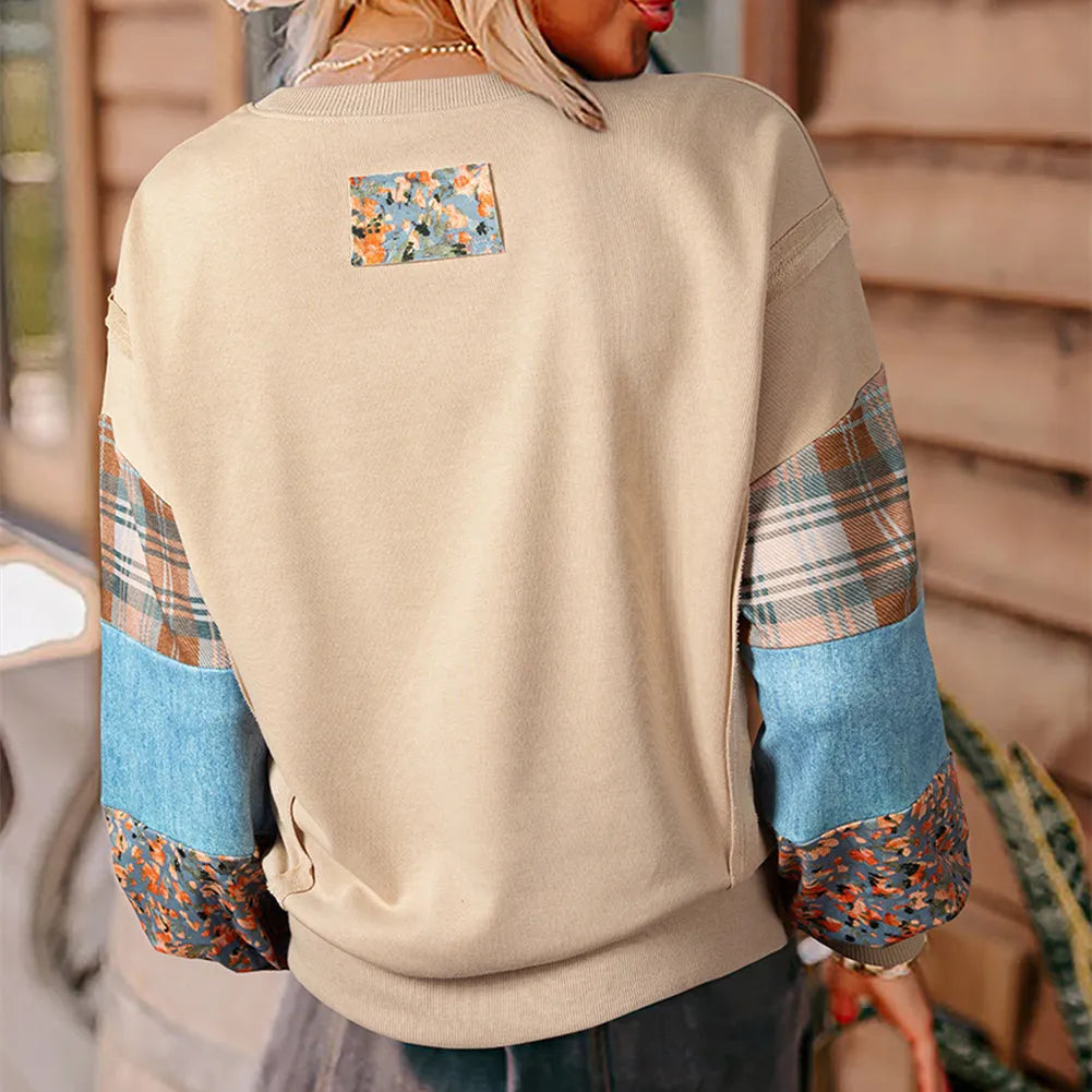 Women's beige and red plaid stitch long-sleeved loose pullover top on a hanger.