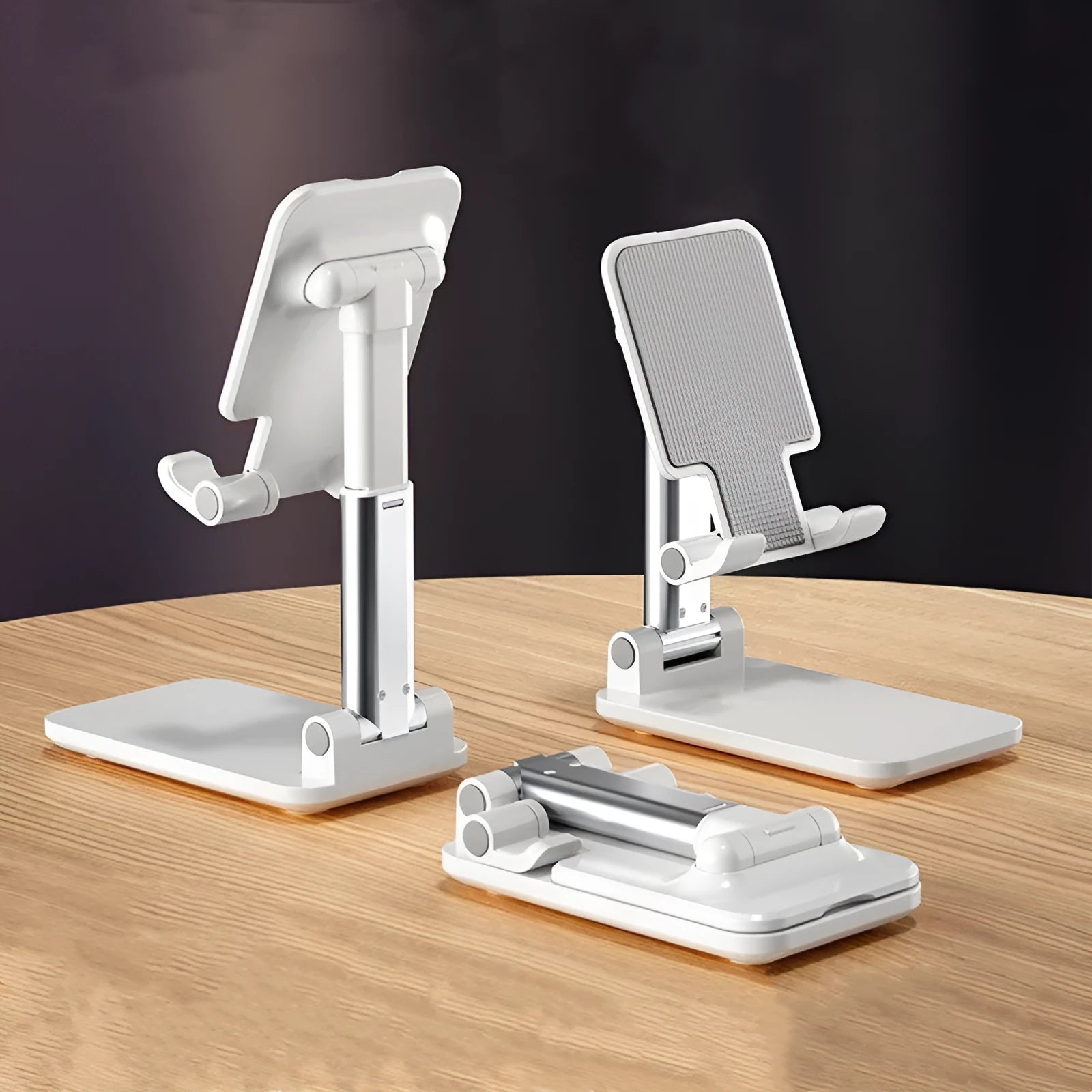 White telescopic folding mobile phone bracket on desktop holding smartphone