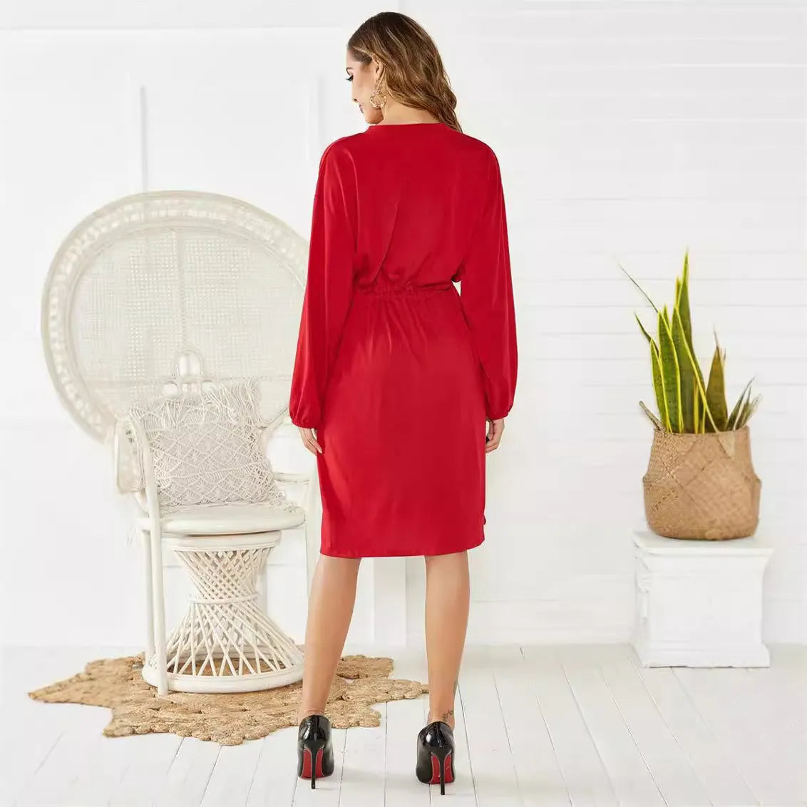 Black A-line dress with elastic waist and cinched belt, mid-length skirt, long sleeves