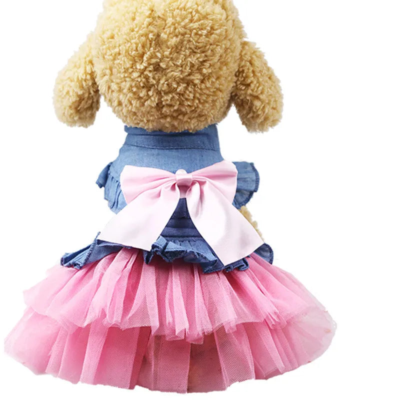 Korean-style denim dog skirt with bow detail in white or pink yarn, shown on a model dog.