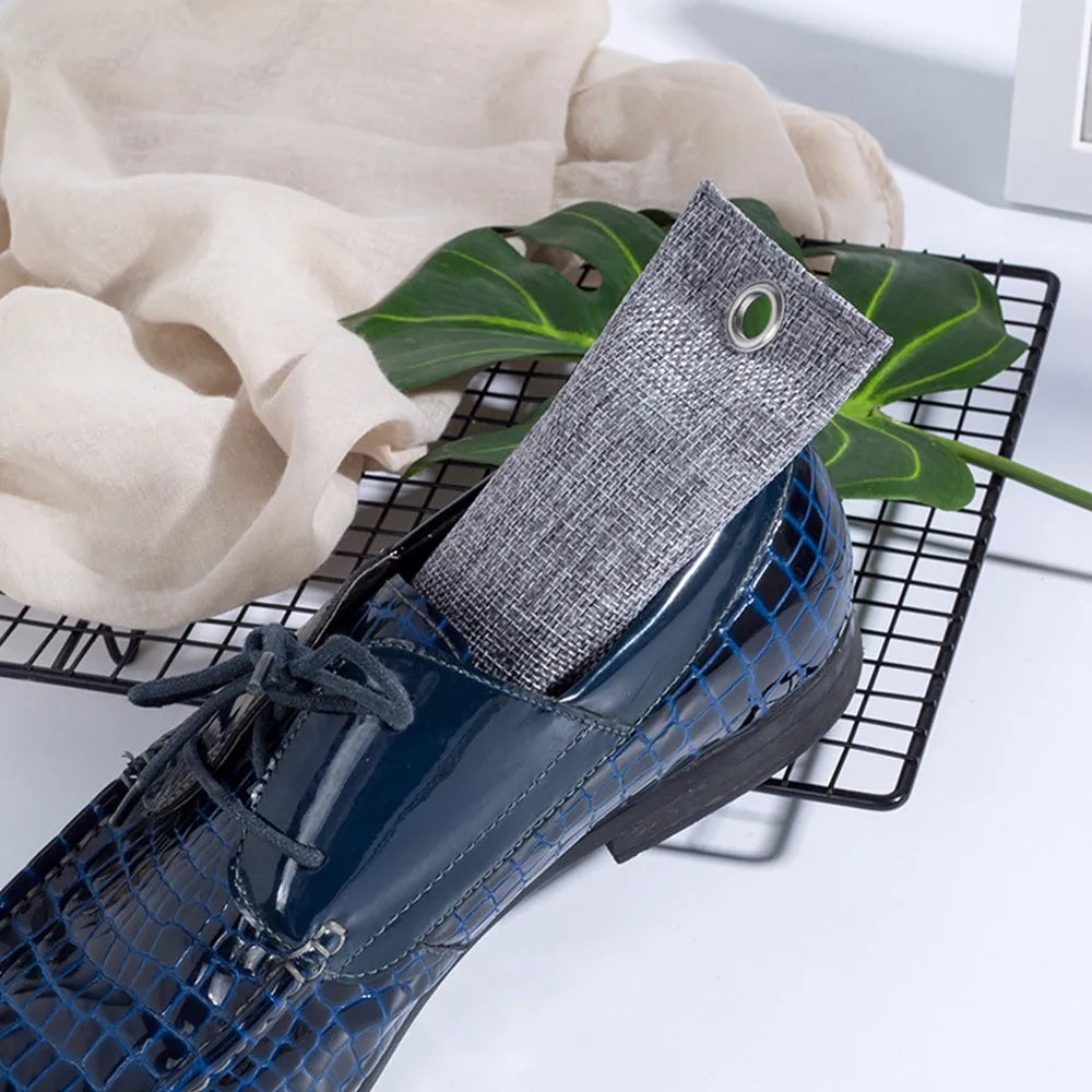 Black, blue, green, and grey linen charcoal deodoriser bags for shoes and household odour removal.