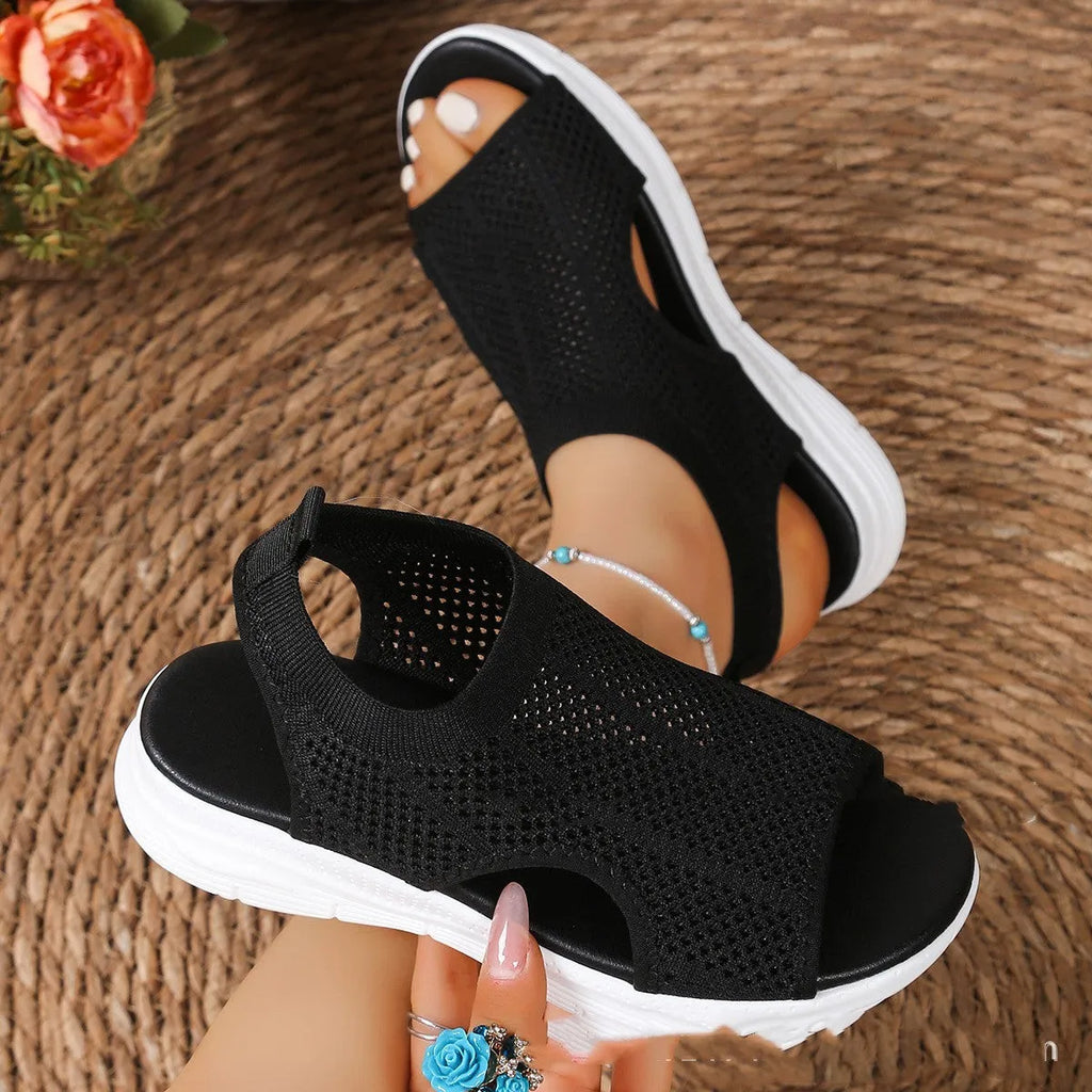 Women's black platform sports sandals with a flat toe bracket and mesh lining on a rubber sole.