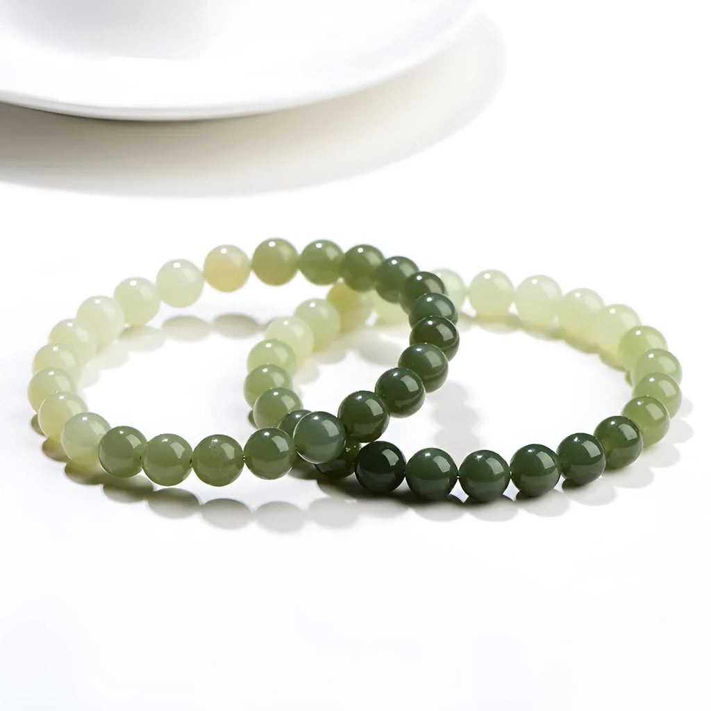 Natural gradient water Hetian jade bracelet with choice of round or barrel beads.