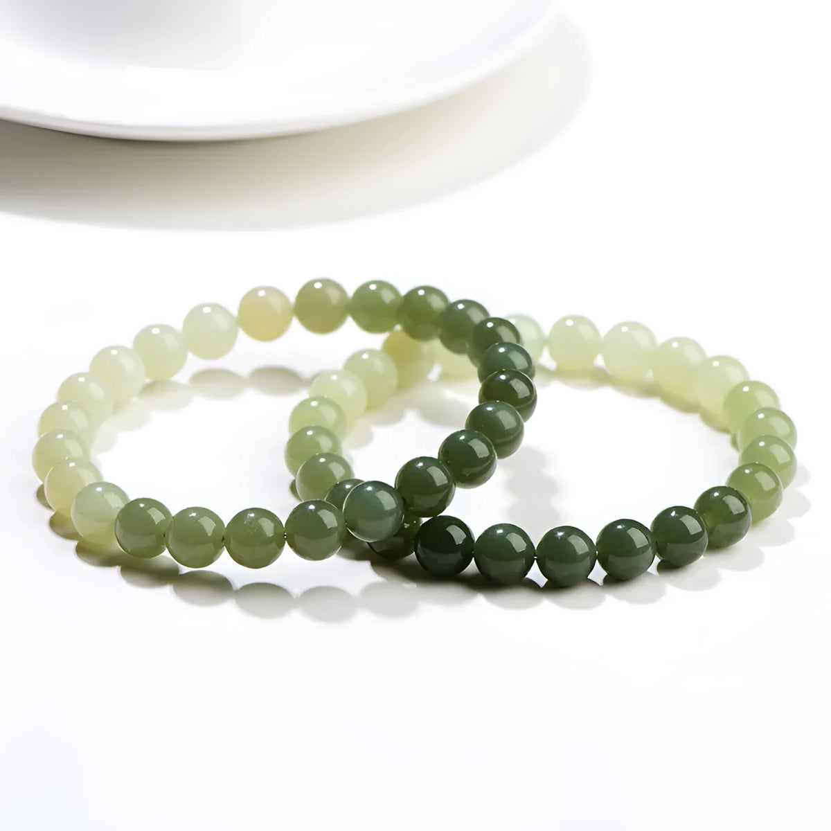 Natural gradient water Hetian jade bracelet with choice of round or barrel beads.