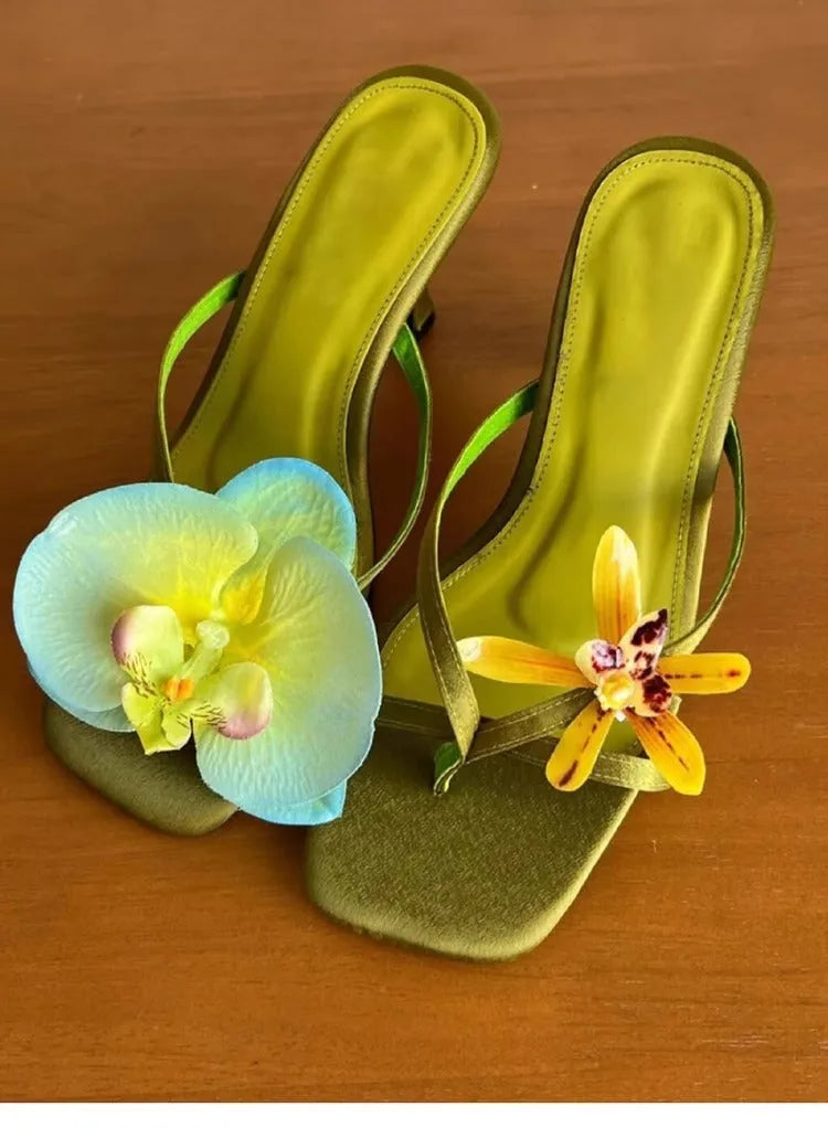 Handmade women's high-heel sandals with square toe and asymmetric floral decoration on calf leather.