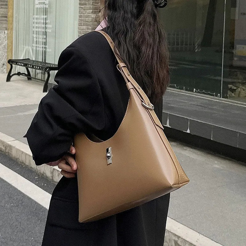 Genuine leather crossbody shoulder bag with dumpling shape, internal organisation pockets, and street trend style details