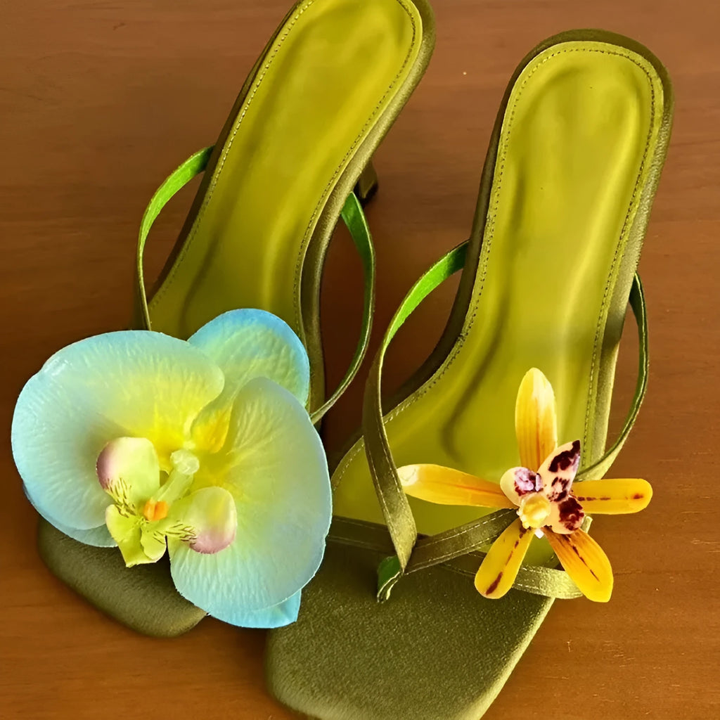 Handmade women's high-heel sandals with square toe and asymmetric floral decoration on calf leather.