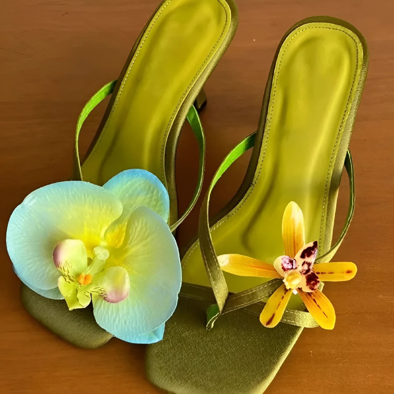 Handmade women's high-heel sandals with square toe and asymmetric floral decoration on calf leather.