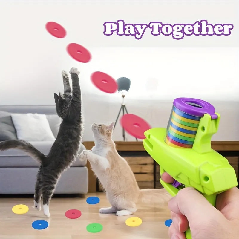 Green interactive cat toy launcher with foam discs on wooden floor