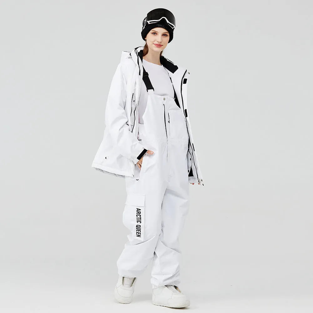 Men's and women's winter ski suit in blue top with grey-blue pants, showing waterproof construction for snow sports