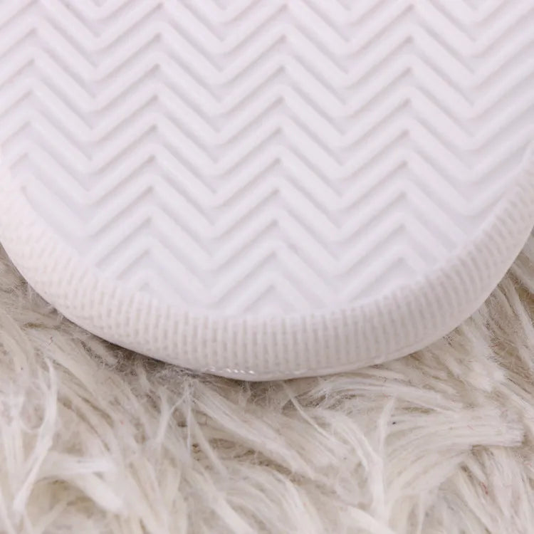 White fluffy cartoon slippers with a plush upper and a non-slip rubber sole.
