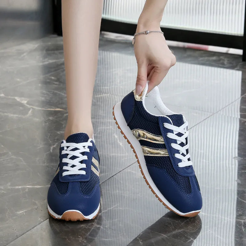 Blue women's lace-up casual sports shoes with cross straps and a flat rubber sole.