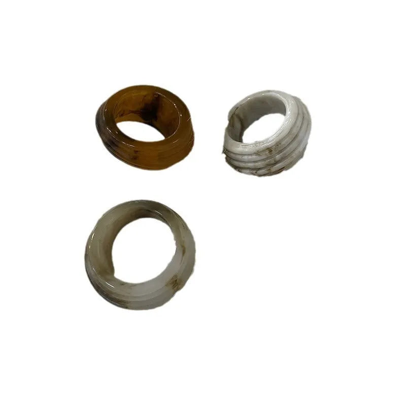 Geometric irregular resin wide ring in brown and white colour options on a hand.