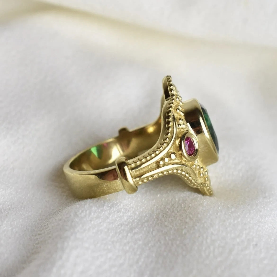 Gold-plated geometric fashion ring for women on grey background showing detailed design