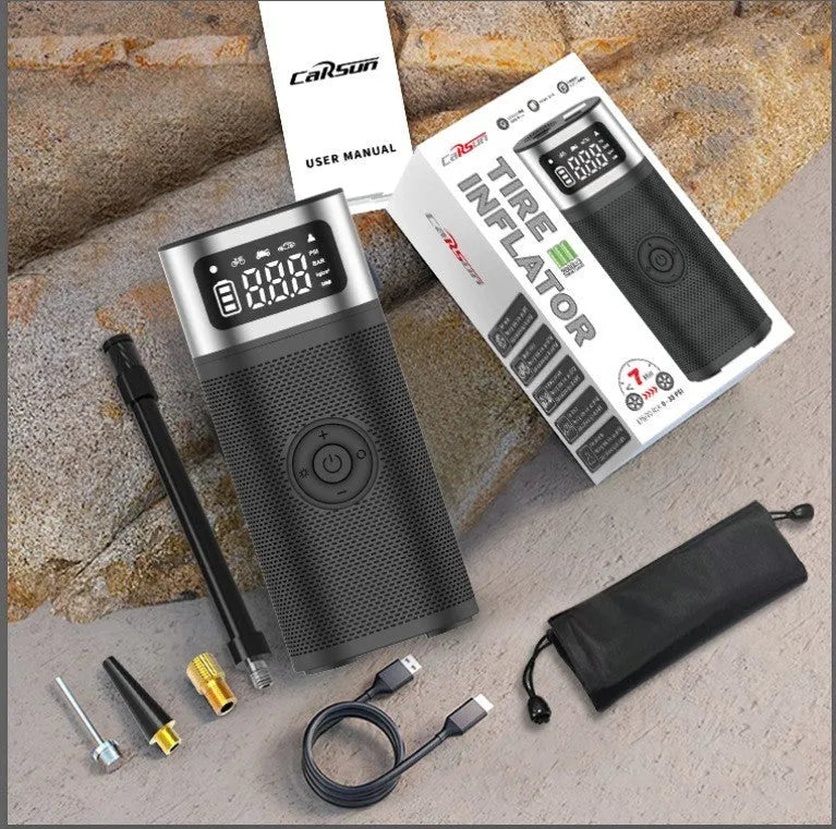 Black portable wireless smart air pump with LCD screen, LED light, inflation tube, and multiple nozzles on a white background.