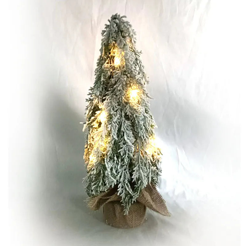 24-inch desktop Christmas tree with PE snow simulation and integrated lighting on wooden surface