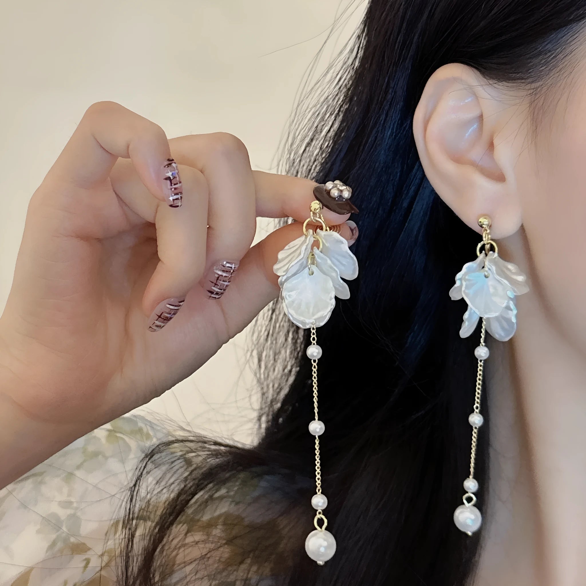 Women's fashion earrings with shell pearl tassel design measuring 8.8cm long, showing clip fastening options