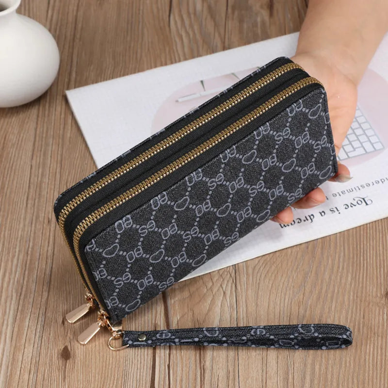 Retro style long wallet clutch in PU leather with a print design, shown in black colour.