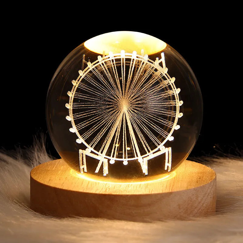 3D crystal ball night light projecting starry sky and planets from its 6cm sphere on a solid wood base.
