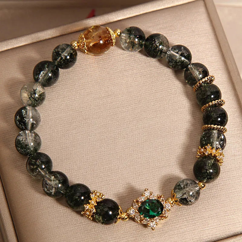 Women's gold rutilated quartz crystal bracelet with green phantom quartz beads and pearl rhinestone accents