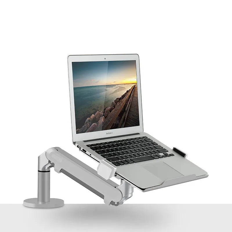 Silver aluminium alloy laptop stand with adjustable height and 360-degree rotation on a wooden desk