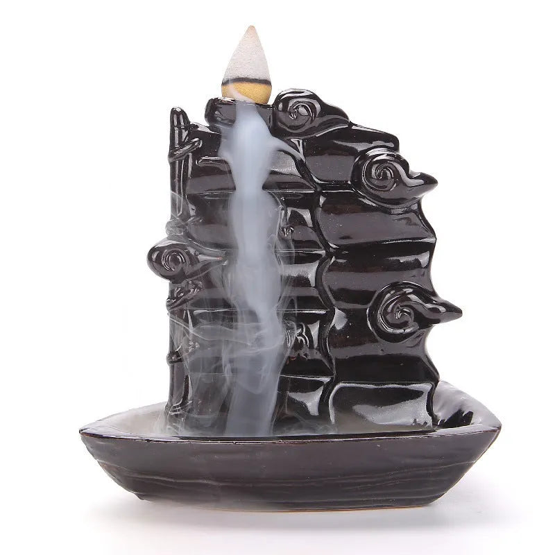Modern ceramic backflow incense burner with sandal ornament in green tree design.