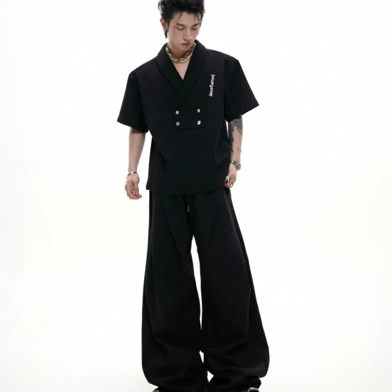 Men's dark grey V-neck sports suit with padded shoulders and metal embellishments on cotton fabric