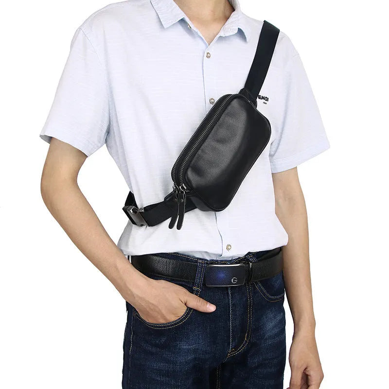 Men's small leather crossbody bag in cowhide showing compact dimensions and urban simplicity styling